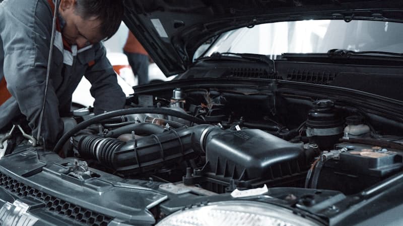Auto repair shop with mechanic working on vehicle