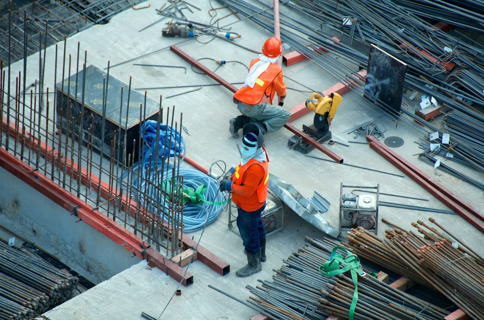 Two construction workers collaborating on site